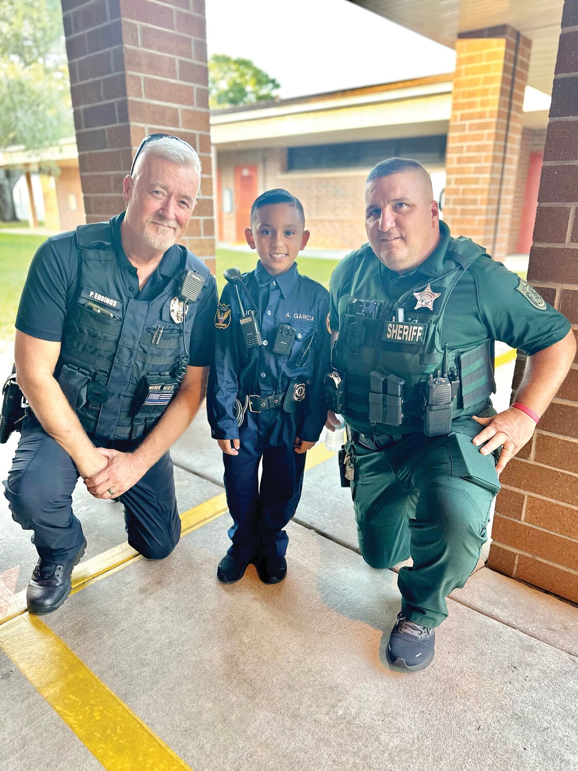 Amarhi is pictured with Officer Eddings (left) and Deputy Higgins (right).